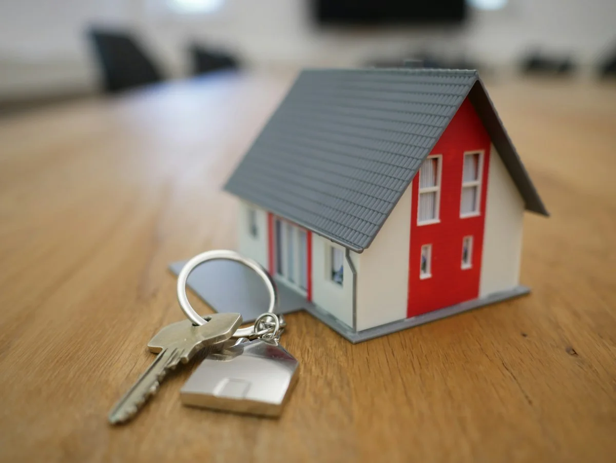 Realistic estate agent keys and house brochure on an English kitchen counter